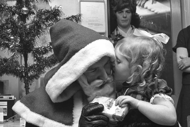 How does Santa get round all those houses on Christmas Eve? In the meantime, here he is taking present requests from children at the Farringdon Playgroup Christmas party in 1976.