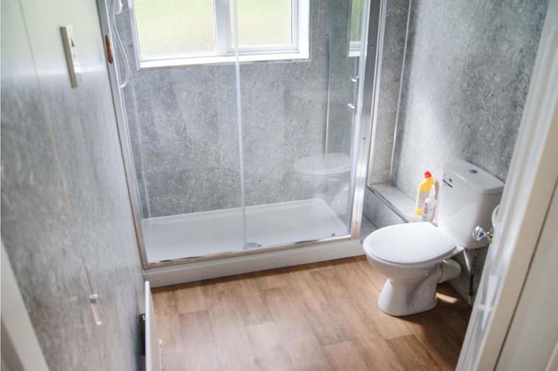 Fully panelled bathroom with three piece suite, wash hand basin with mixer tap, fully enclosed double shower cubicle and WC, extractor fan, window provided natural light and ventilation, central heating radiator and low maintenance flooring