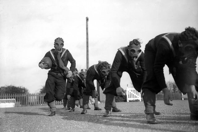 22nd January 1934:  Able seamen at the Royal Navy Anti-Gas School at Tipnor, Portsmouth play ball games wearing gas masks, to accustom them to carrying out strenuous tasks in respirators.  (Photo by William Vanderson/Fox Photos/Getty Images)