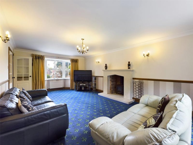 Lounge - Feature stone fireplace with raised hearth incorporating the gas burner, French style doors to the rear.