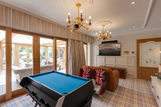 Currently used as a games room, this space could also be utilised as a playroom, study or additional sitting room, with double sliding oak doors leading to the open plan dining kitchen and sitting room.