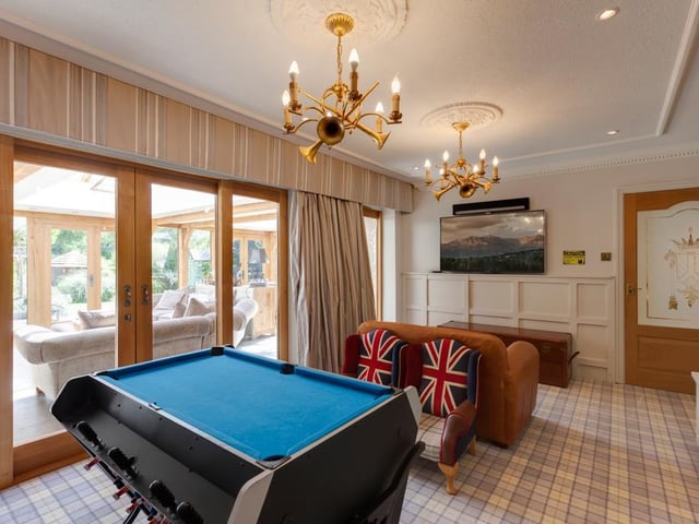Currently used as a games room, this space could also be utilised as a playroom, study or additional sitting room, with double sliding oak doors leading to the open plan dining kitchen and sitting room.
