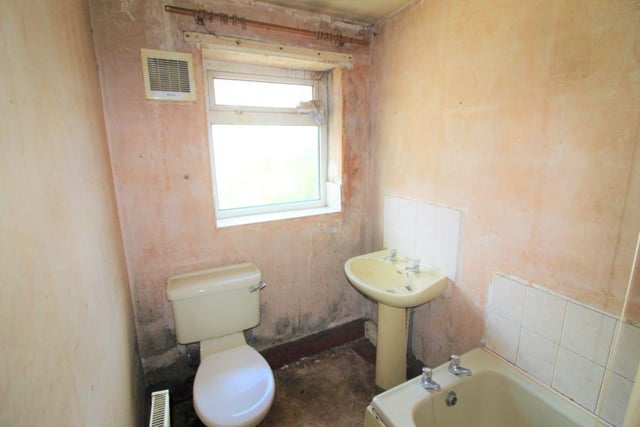 The bathroom is located downstairs next to the kitchen and dining room. It has been fitted with a sink, toilet and bath.
