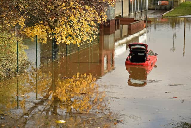 An abandoned car submerged in flood water in Rotherham (Photo by OLI SCARFF/AFP via Getty Images)