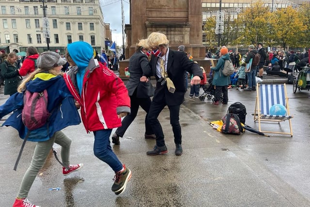 Protesters dressed up as Prime Minister Boris Johnson dancing in George Square.