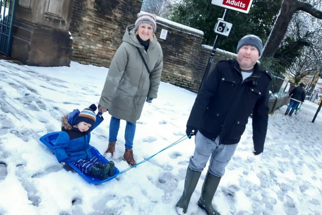 A family enjoying the snow in Weston Park