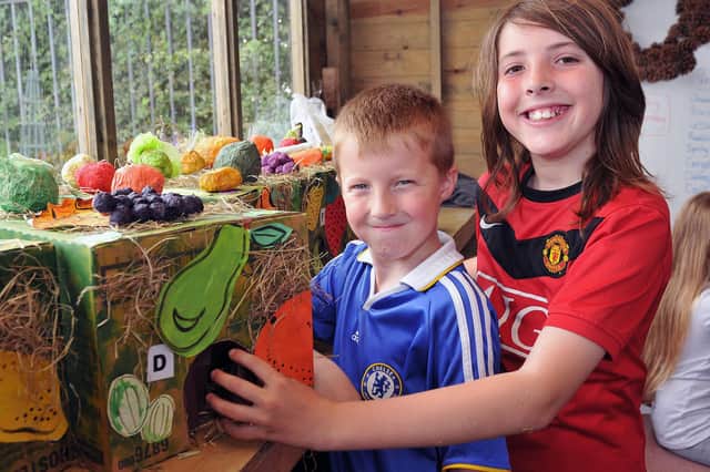 Cousins Connor Smith (left) and Matthew Lake try to guess what is inside the box during the Waverley allotment fun day. Remember this from 2012?