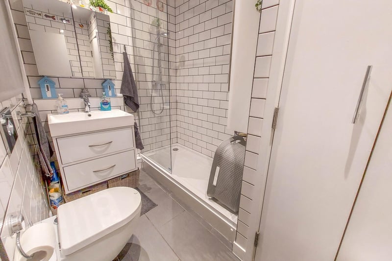 Clever design makes the most of the space with a walk-in shower and storage space.