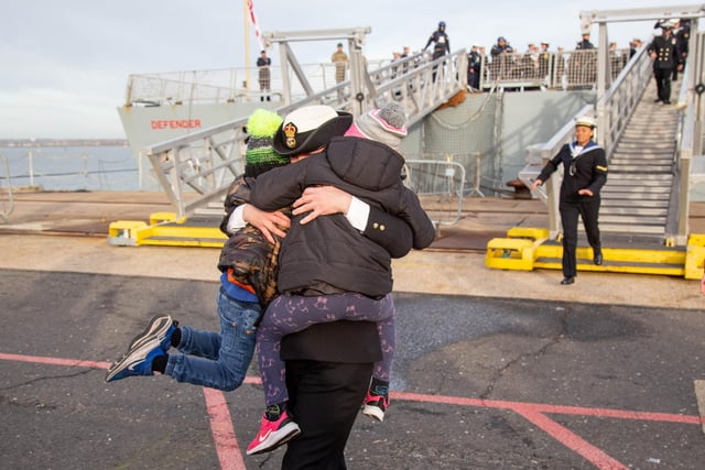 Jenni Smith embraces er children Evelyn 7 and Matthew 5 as she steps of HMS Defender. Picture: Habibur Rahman