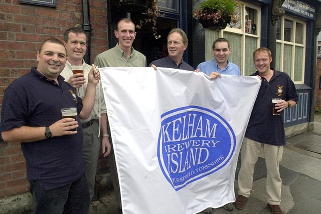 HMS Sheffield crew pictured with the flag of Kelham Island brewery at the Fat Cat.  Brewery boss Dave Wickett is fourth left, October 2001