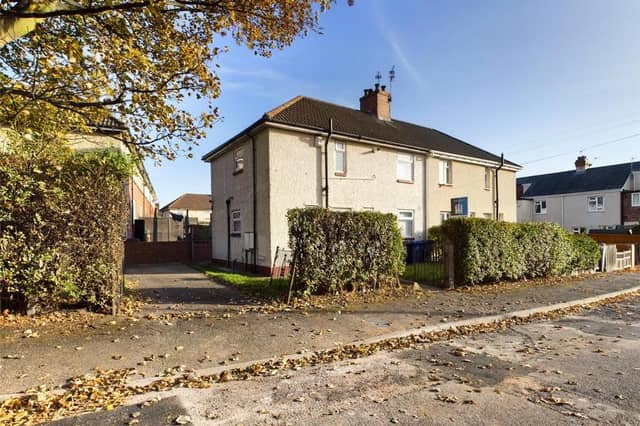 Hedge enclosed with wrought iron access gates, laid to lawn with raised flower bed, paved path and hard standing; access gate opening into the rear garden.