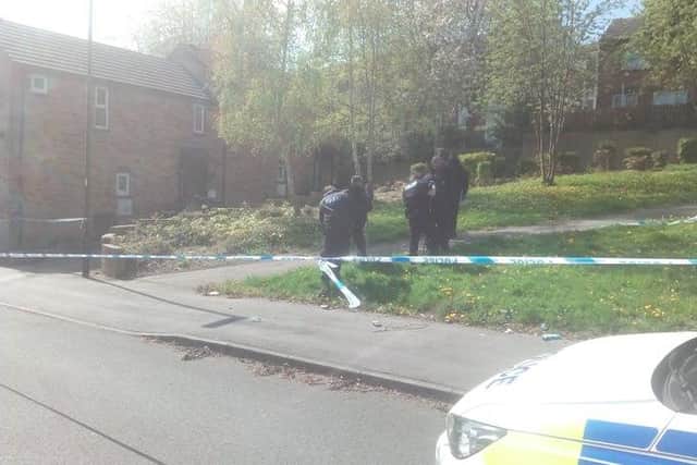 Police officers searching Burngreave after a shooting yesterday.