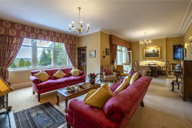 The elegant and extensive drawing room is L-shaped with handcrafted fitted cabinets and has garden views and access into the delightful conservatory.