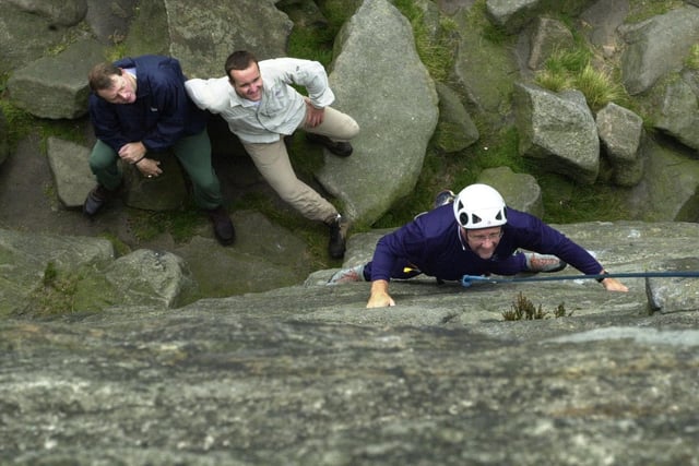 Richard Caborn, MP climbing Stanage Edge  with timeoutdoors.com which has relocated to Sheffield from the Thames Valley, watched by Sheffield first chief executive, left and timeoutdoors managing director Andrew Risbey back in 2002