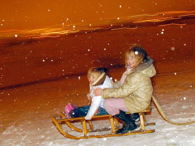 Alicia, 3, and Marie King, 8, enjoy the snow on Fisher Lane Recreation Ground in 2009