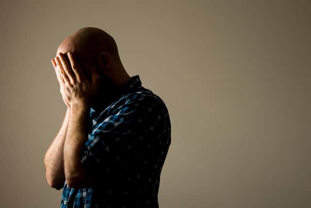 Picture posed by a model. A man showing signs of depression.