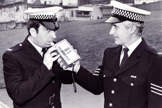 P.C. Charles Auty (left) and Sgt John Fryer of South Yorkshire Police in Sheffield with the new Draeger electronic roadside breathalyser box which is replacing the bag and tube, March 1986