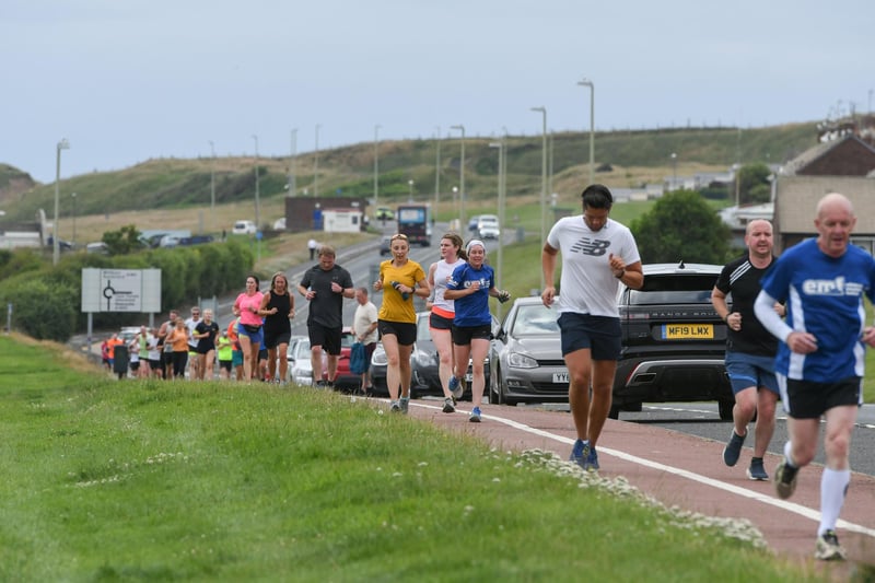Runners on the final stretch of the 5k parkrun route along the Coast Road in South Shields.