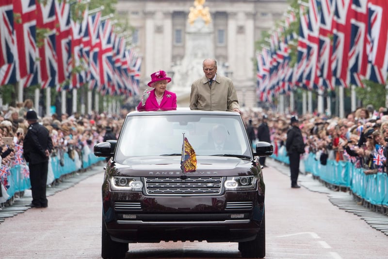 The Queen and Prince Philip wave to 10,000 guests on The Mall who attended 'The Patron's Lunch' celebrations for Her Majesty's 90th birthday in 2016. (Photo: Arthur Edwards/Getty Images)