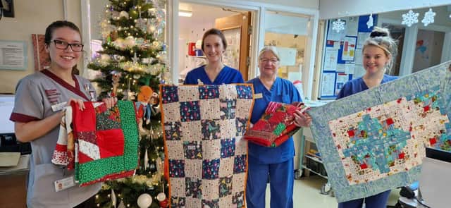 Nurse accepting quilts at Rotherham Baby Unit