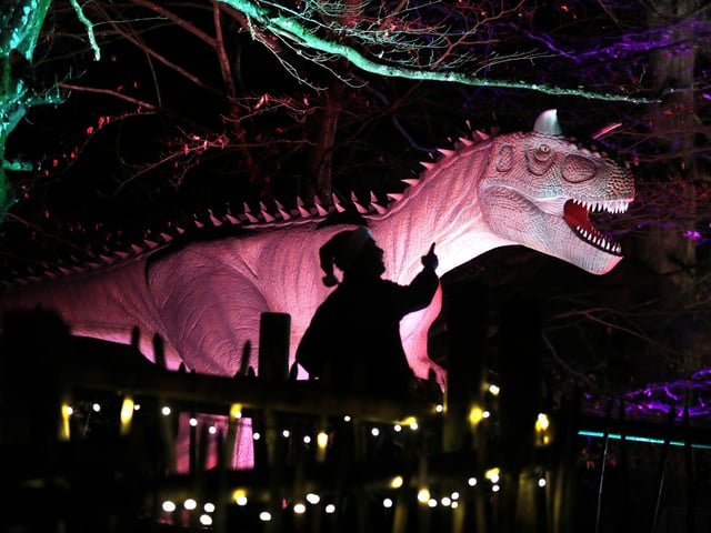 Visitors to Blair Drummond Safari Park near Stirling, Scotland, enjoy the illuminations installed in the Safari Park's new 'World of Dinosaur' exhibit.