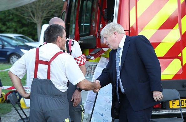 Prime Minister Boris Johnson met with rescue crews at Whaley Bridge Football Club as work continued at Toddbrook on August 2, 2019