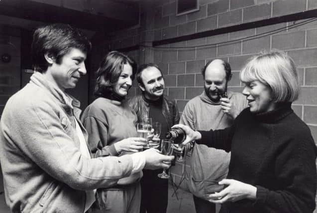 Pictured left to right actors Michael Irving and Deborah Findlay, set designer Roger Glossop, author Rony Robinson, and Clare Venables serving champagne, December 29, 1981.