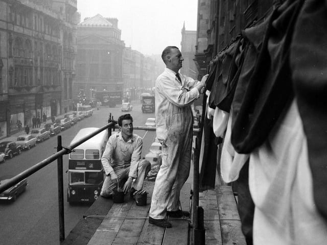 Workmen decorate The Scotsman building on North Bridge in preparation for the King Olav of Norway's state visit to Scotland in October 1962.