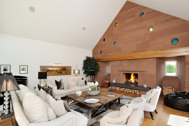 A large open fireplace sits at the centre of the lounge area, with plenty of seating surrounding it to provide a cosy space to relax.