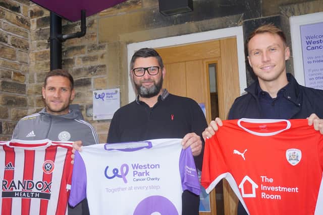 Sheffield United skipper Billy Sharp, Darren Hayes, business development manager at Weston Park Cancer Charity and Barnsley striker Cauley Woodrow