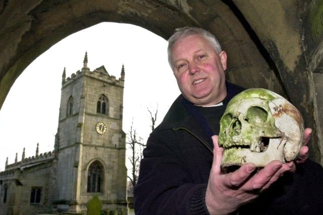 Rev Delves holding a skull outside Hickelton church in 1999.
