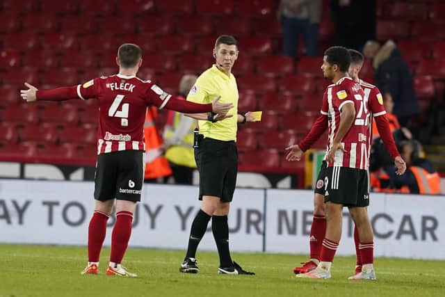 Sheffield, England, 19th October 2021. John Fleck of Sheffield Utd (L) speaks to the referee Matthew Donohue  during the Sky Bet Championship match at Bramall Lane, Sheffield. Picture credit should read: Andrew Yates / Sportimage