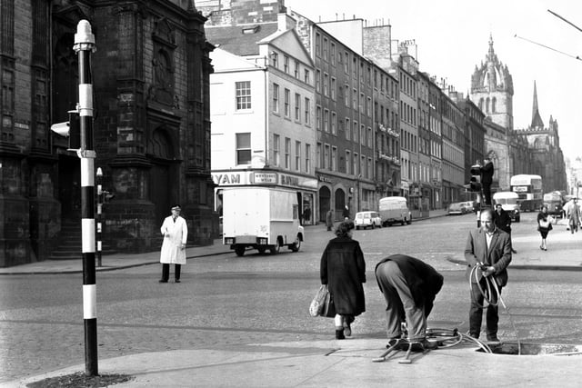 Workmen are shown fitting a new 'progressive' traffic light system at the Tron in March 1966.