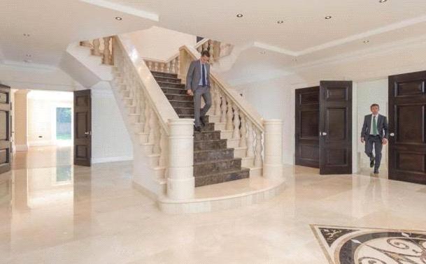 This property features a grand entrance hallway with staircase leading up to the first floor