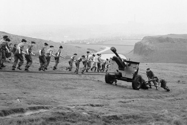 The Field Regiment of the Royal Artillery attempt to haul a 25-pounder gun from Dunsappie Loch to the saddle of Arthur's Seat as part of a training exercise in May 1966.
