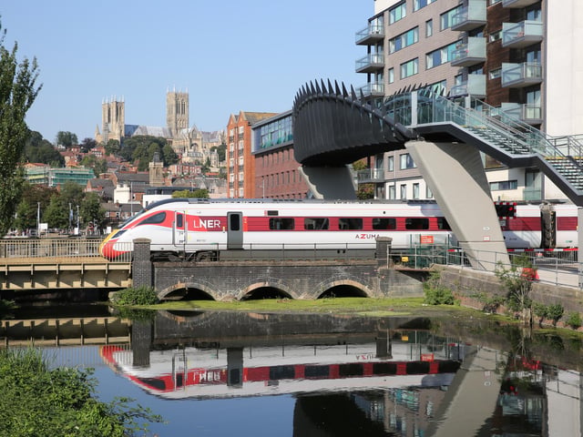 An LNER train passes through the city of Lincoln.