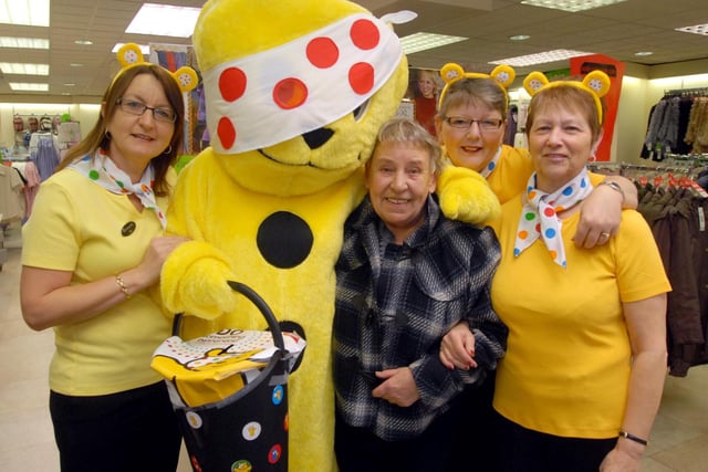 A customer and staff had a cuddle with Pudsey Bear at Bon Marche in Bulwell in 2009