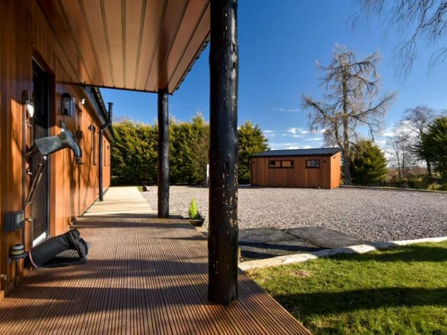 This is the entrance to the home, and you can see the garden room in the background. This room is currently used as a workshop, but it could be easily adapted into a home office or a studio depending on your needs