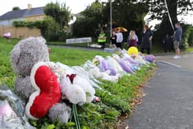 Members of the public place flowers at the entrance of Biddick Drive on August 15, 2021 in Plymouth, England. (Photo by William Dax/Getty Images)