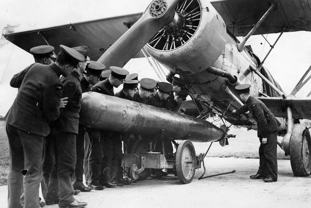 February 1937:  A tropedo being attached to a 'Fairey Swordfish' plane at the RAF Station at Gosport.  (Photo by Keystone/Getty Images)
