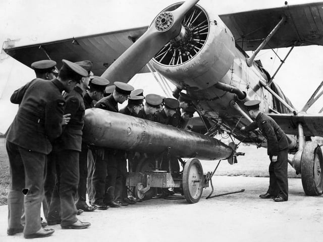 February 1937:  A tropedo being attached to a 'Fairey Swordfish' plane at the RAF Station at Gosport.  (Photo by Keystone/Getty Images)