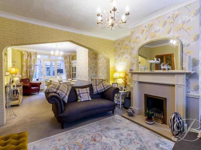 This alternative view of the living room shows how bright and spacious the open-plan area is. in the background, you can see the dining room, which has a carpeted floor and a central-heating radiator.