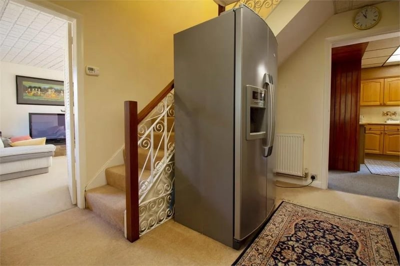Stairs to first floor. Fitted carpet flooring. Under stair storage space.