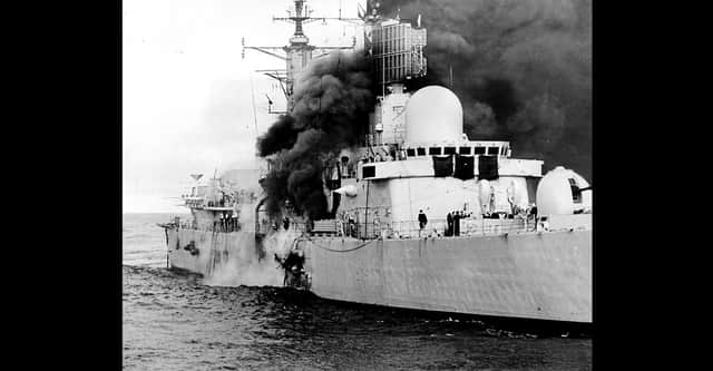 HMS Sheffield burns shortly after being hit by an Argentine Exocet missile, on 4/5/1982, whilst on RADAR picket duties off the coast of the Falkland Islands.  