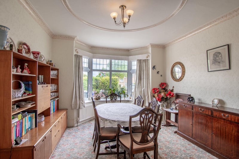 The dining room offers plenty of space and features a lovely bay window.