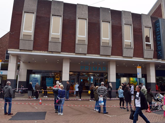 Shoppers queue to enter Primark.