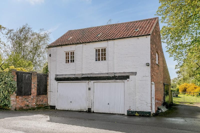 The period two-storey coach house has garaging  on the ground floor and an enclosed staircase to a first floor studio/office space