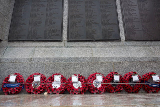 Wreaths laid beneath the inscriptions of Hartlepool's war and military dead at the town's Victory Square war memorial.