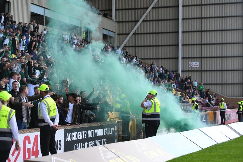 A green smoke canister was thrown onto the trackside from the Hibs end