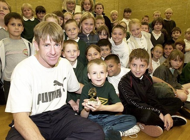 Pictured at Greengate Primary School, High Green, Sheffield, where pupil Daniel Booth (8) is seen receiving a special award from Steve Adams from Sheffield Wednesday's Football in the Community scheme, on July 4, 2000